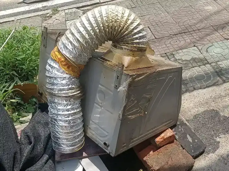 Crumpled foil flexible duct attached to a taped metal box