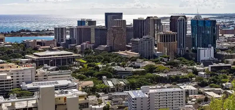 Downtown Honolulu towers with the ocean behind, seen from Punchbowl Crater